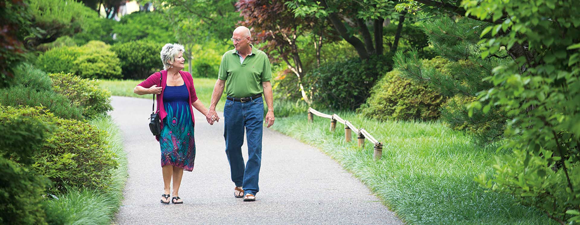 older couple walking through the gardens