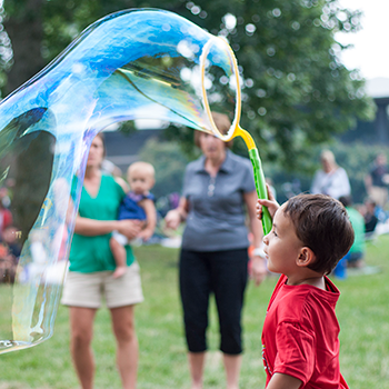 members picnic, kid holding a giant bubble